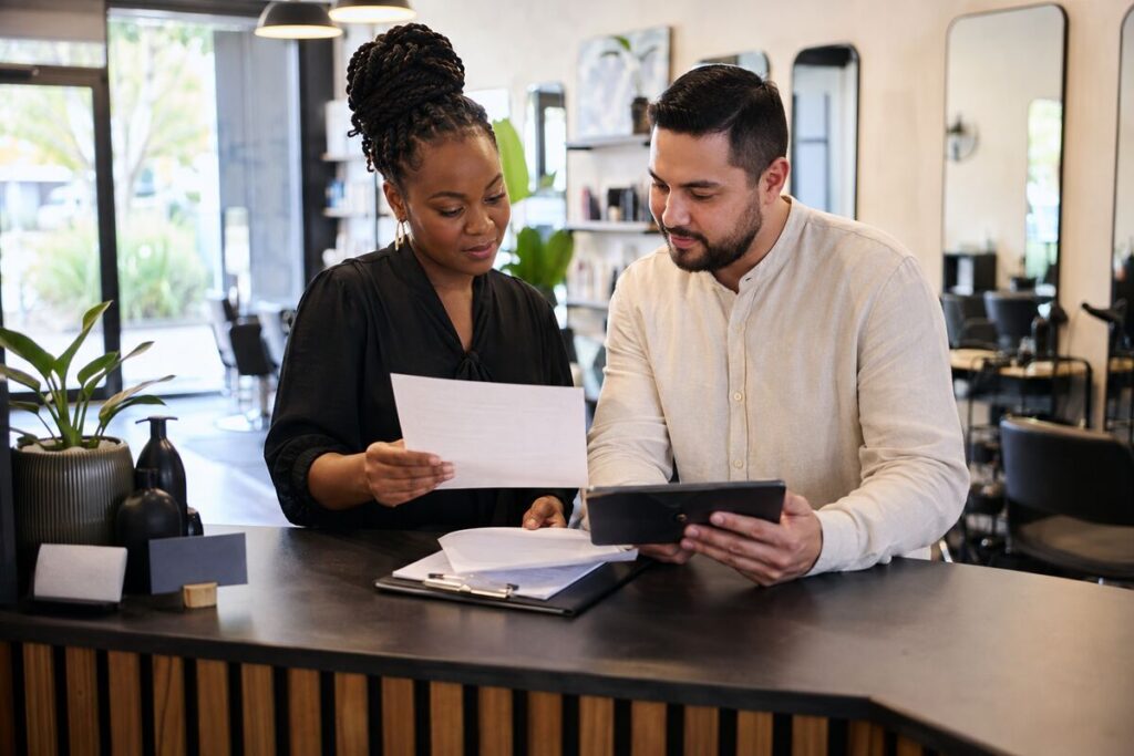 Tax Advisor Fort Lauderdale reviewing Florida sales tax records with a salon owner