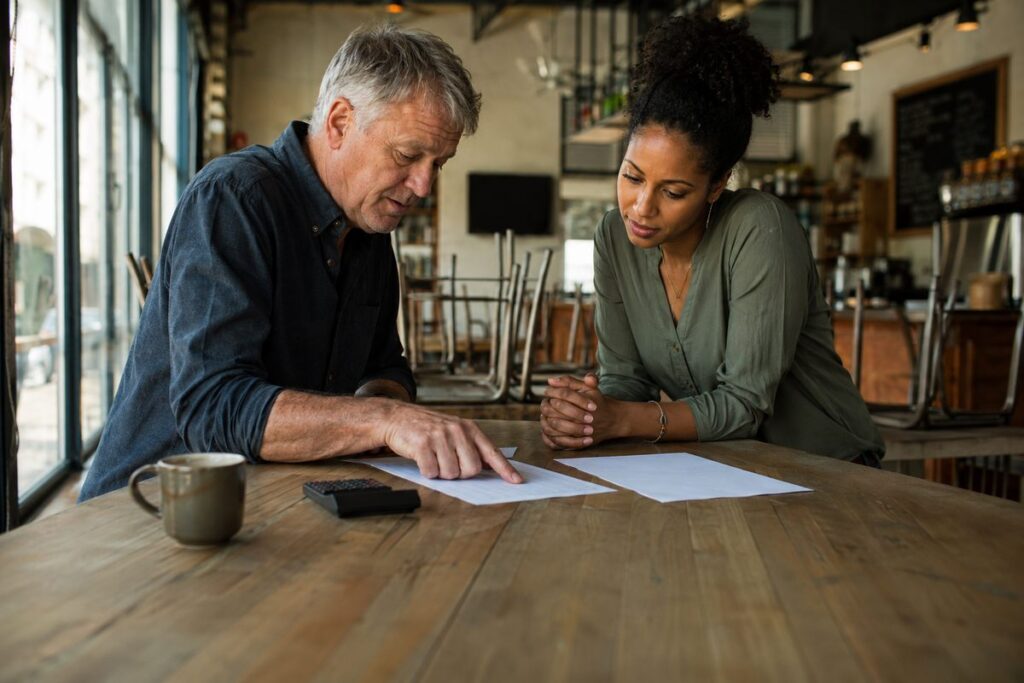 Accountant Fort Lauderdale helping a cafe owner review break-even costs and sales targets
