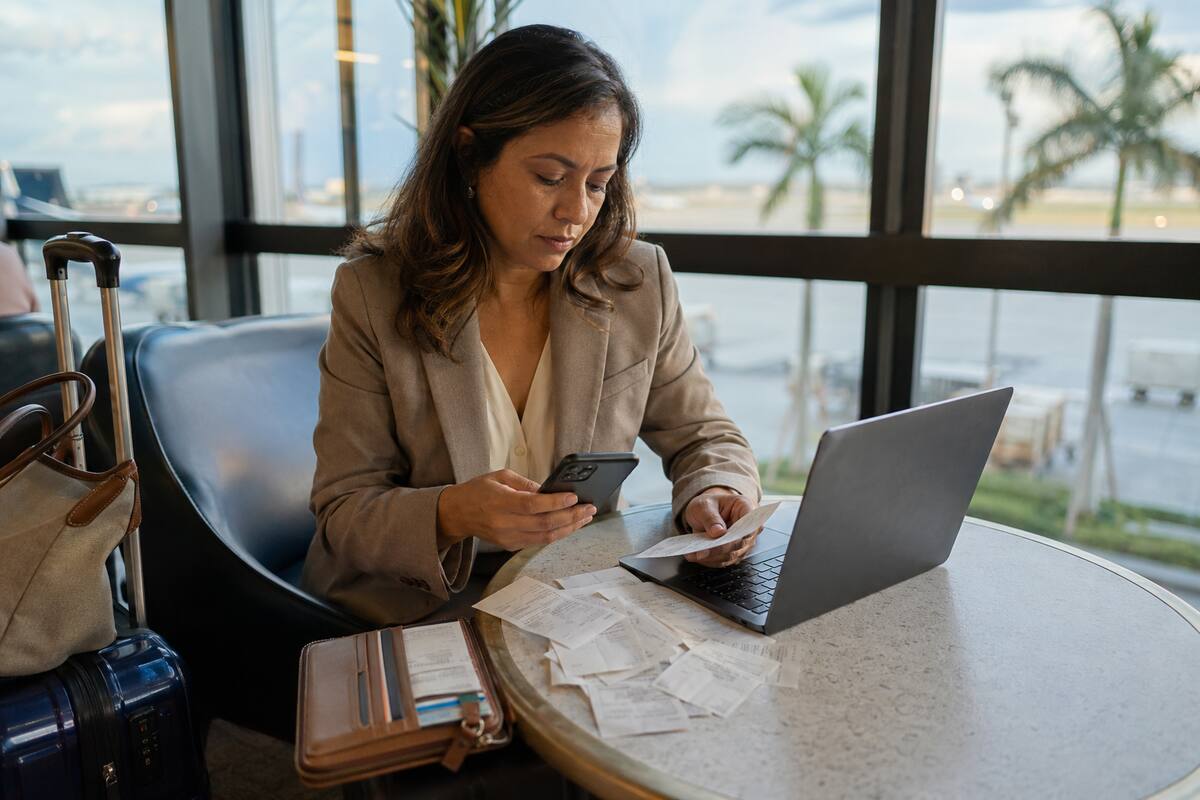 A business traveler organizes meal receipts, travel records and expense notes