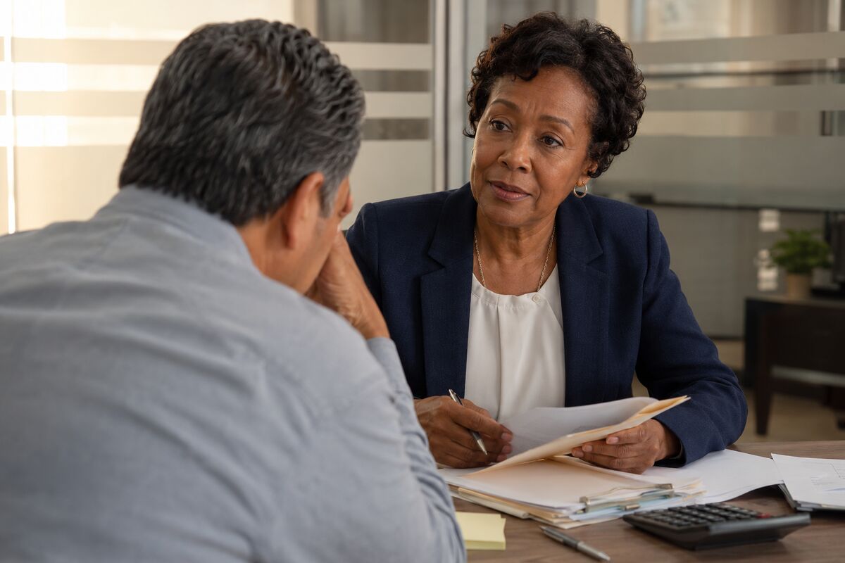 A taxpayer and tax advisor review records of income, expenses and assets